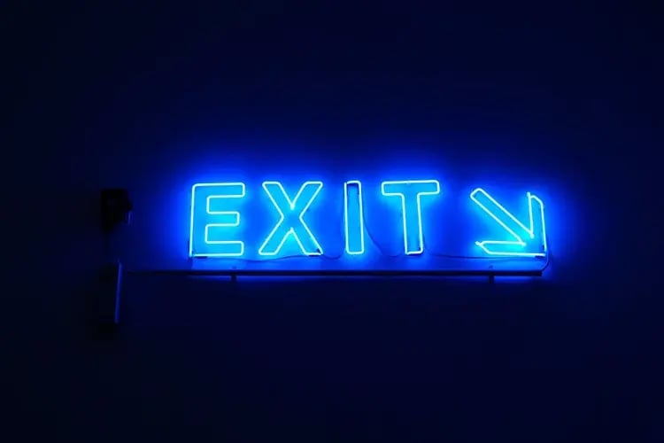 A neon sign with an arrow and the word 